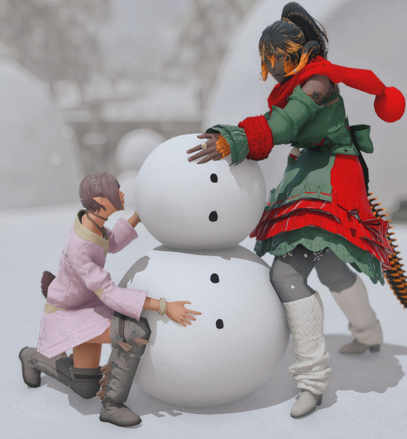 Argilenne and her niece, Lycelle making snowmen